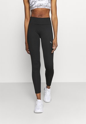 Leggings sportivi neri con vita alta, progettati per il comfort e la flessibilità. Presentano un piccolo logo bianco sulla coscia.