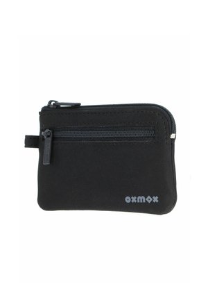 Pochette à monnaie compacte en tissu noir avec deux compartiments zippés et une petite languette en tissu sur le côté.