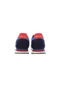 Navy suede sneaker with red accents and white soles. Features a textured mesh design, padded collar, and "SINCE 1890" lettering on the heel.