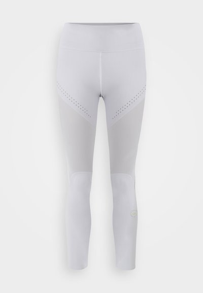 Witte legging met een hoge tailleband, voorzien van gaaspanelen en kleine perforaties op de dijen. Subtiele logodetail nabij het onderbeen.