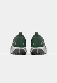 Green athletic shoes with a soft, textured upper, reflective accents, and a solid gray sole featuring a tread pattern.