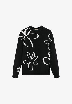 Pull noir à col rond, orné de motifs floraux blancs de formes et de tailles variées tricotés sur le devant et les manches.