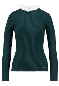 Dopasowany, prążkowany top z długim rękawem w ciemnym morskim kolorze z białą, falbaniastą linią dekoltu. Posiada dopasowany krój i subtelne logo marki przy dole.