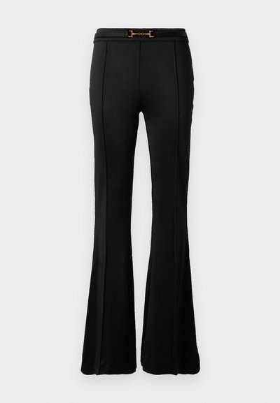 Black high-waisted flare pants with front seam detailing and a thin belt featuring a gold horsebit buckle at the waist.