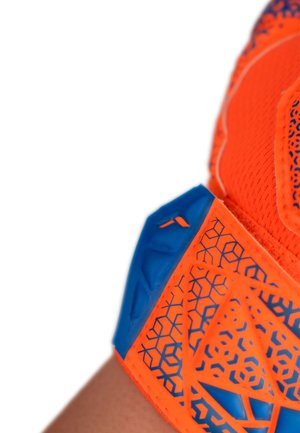 Close-up of an orange and blue patterned sports glove wrapped around a wrist against a white background.