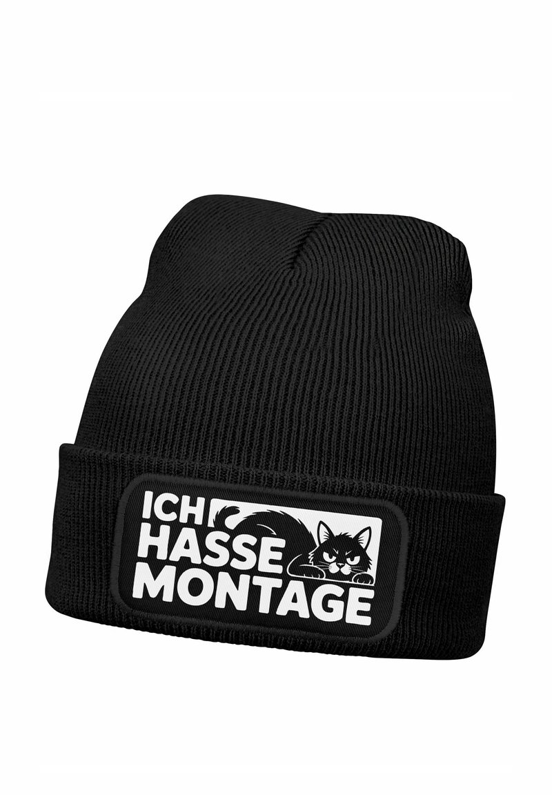 Black knitted beanie featuring a ribbed texture and a rectangular patch with a black and white cat illustration and German text.