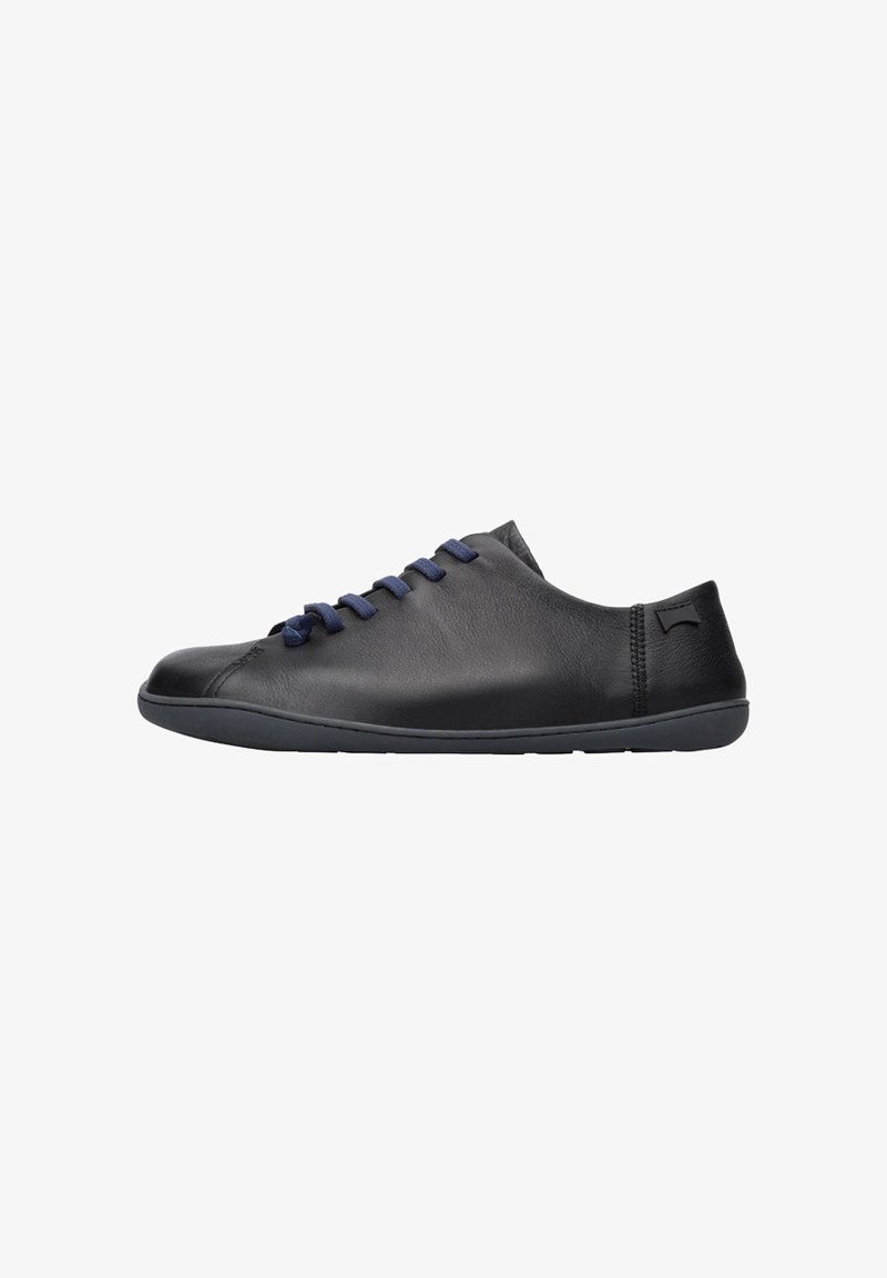 Black leather shoe with blue laces, low profile design, smooth texture, and flexible rubber sole. Features subtle branding detail.
