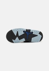 Blue and black sneaker sole with a textured pattern, featuring a large blue logo, and a mix of solid and translucent rubber sections.