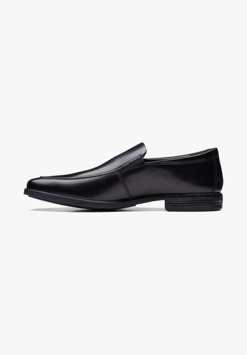 Black leather slip-on shoe with a pointed toe, polished finish, subtle stitching details, and a low profile rubber sole.