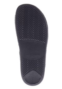 Black rubber shoe sole featuring a herringbone pattern, with embossed text "PRODUCED BY WALDI," "Made in Germany," and size "38."