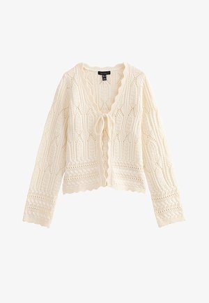 Cardigan lavorato a maglia color crema con maniche lunghe, bordi smerlati, motivi di pizzo intricati e chiusura frontale con fiocco.