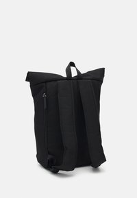 Black backpack made of durable fabric, featuring a roll-top design, adjustable shoulder straps, and a side zipper pocket for storage.