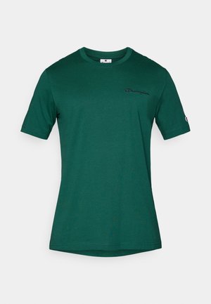 Tricou Champion de culoare verde închis, cu mânecă scurtă, având logo brodat pe piept și o mică etichetă cu logo pe mâneca stângă.