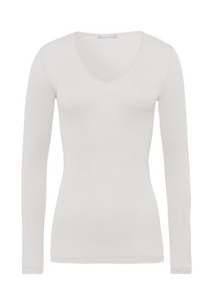 Langsleeve, v-hals top van lichtgewicht witte stof. Slanke pasvorm met een nette textuur en subtiele stikdetails langs de halslijn en mouwen.