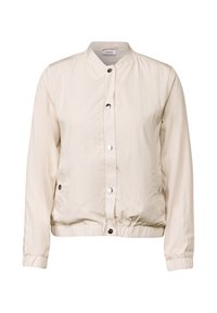 Lichtbeige bomberjack gemaakt van gekreukt stof, met een staande kraag, drukknoopsluiting en elastische manchetten en onderrand. Twee zijzakken.