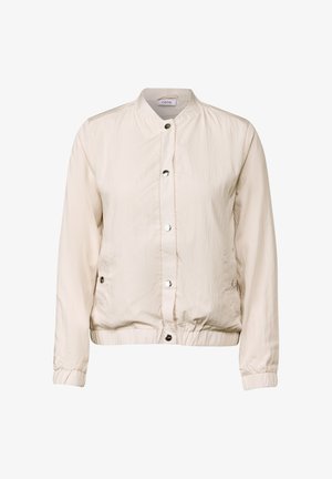 Veste bomber beige clair en tissu froissé, dotée d'un col montant, de boutons-pression et de poignets et d'ourlets élastiques. Deux poches latérales.