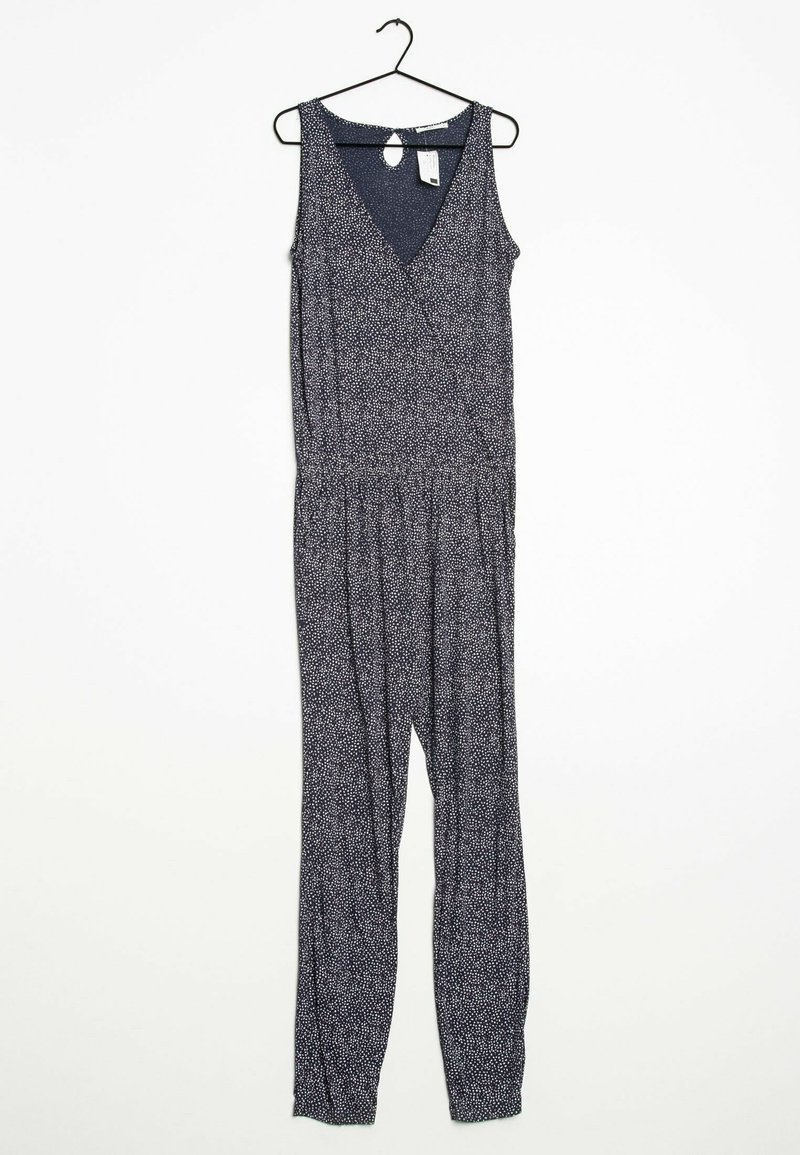 Marinblå ärmlös jumpsuit med V-ringning, elastisk midja och små vita blommor. Hänger från en svart krok.