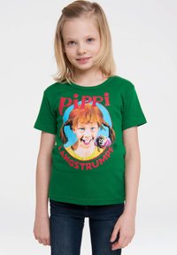 Green cotton t-shirt featuring a colorful graphic of a character with red hair, text reading "Pippi Langstrumpf," and blue circular background.