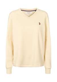 Roomkleurig shirt met lange mouwen, V-hals en geribbelde manchetten, met het label van U.S. Polo Assn. aan de binnenkant van de kraag en een klein geborduurd polo-spelerlogo op de linkerborst.