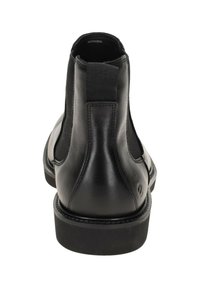 Svarta läderankelboots med elastiska sidopaneler, rund tå och en platt gummisula. Har robust sömnad och diskret branding på hälen.