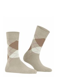 Chaussettes montantes beiges avec un motif argyle présentant des accents de brun clair, de blanc et de rose. Fabriquées en matériau tricoté texturé.
