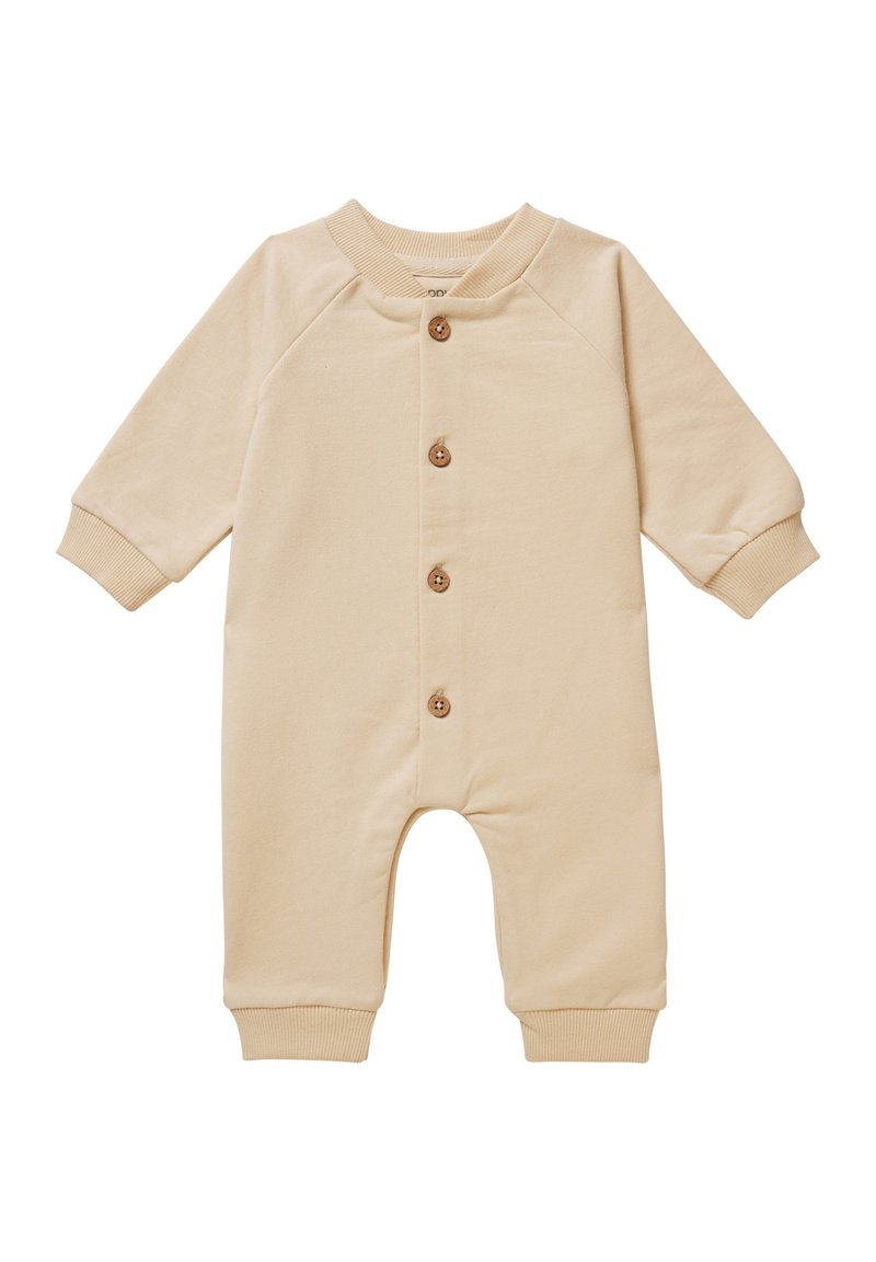 Salopette en coton beige avec des manches longues, des poignets côtelés et un col rond ; présente cinq boutons en bois sur le devant.
