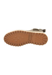 Braune Gummisohle mit einem strukturierten Muster, das dreieckige Noppen für mehr Traktion aufweist. Verstärkte Kanten mit einer hellen Zwischensohle.