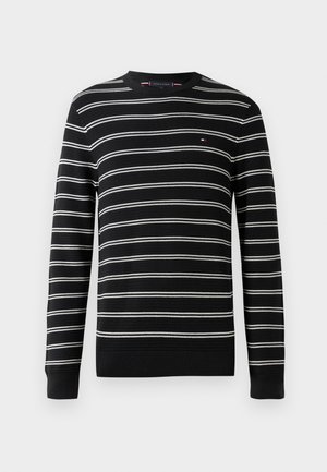 Fekete-fehér csíkos pulóver kerek nyakkivágással, hosszú ujjakkal és bordázott mandzsettákkal, mellén egy kis logóval.