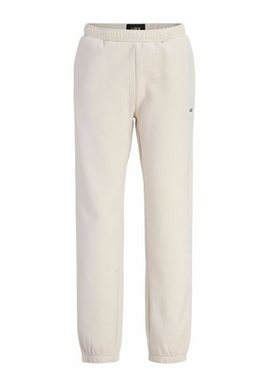 Pantalon de survêtement beige avec taille élastique, poignets aux chevilles et petit logo sur la cuisse droite, présenté sur fond blanc.