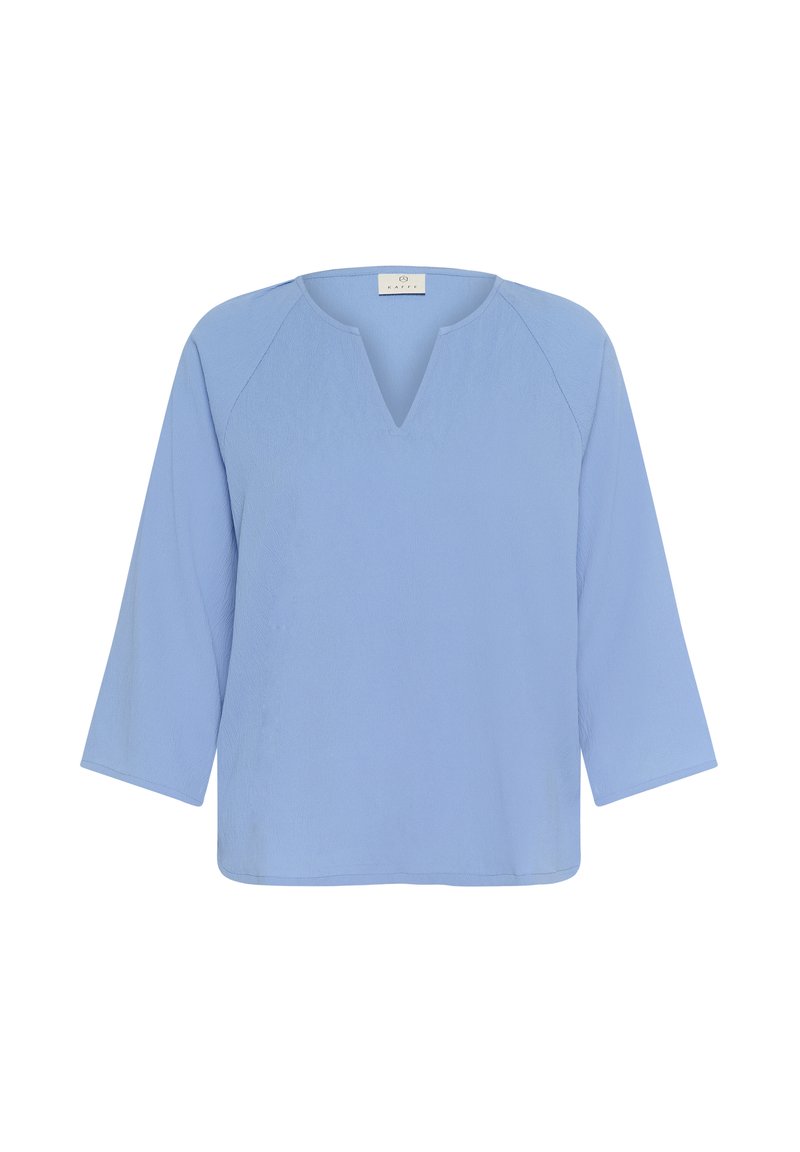 Blouse bleu clair à manches longues avec un décolleté en V et une coupe ample et décontractée.