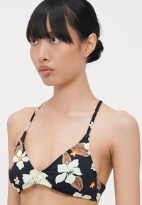 Black floral bikini top with light and dark floral patterns. Adjustable thin straps and triangular cups, made from smooth fabric.