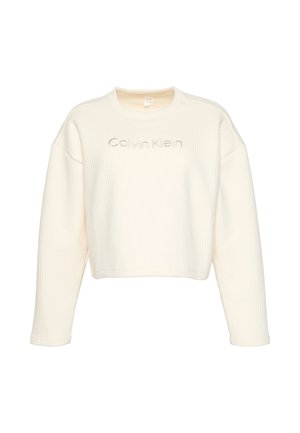 Cremefarbener, kurz geschnittener Pullover mit Rippstruktur, breiten Ärmeln und rundem Ausschnitt. Verziert mit dem "Calvin Klein"-Logo in tonaler Stickerei.