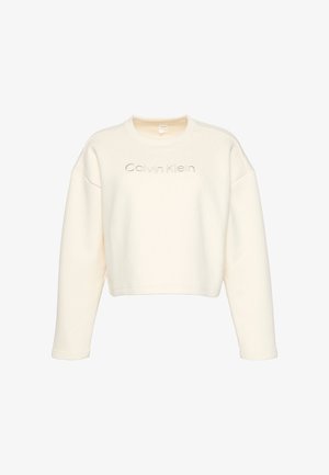 Sudadera corta color crema con textura acanalada, mangas anchas y cuello redondo. Presenta el logotipo "Calvin Klein" en bordado tonal.