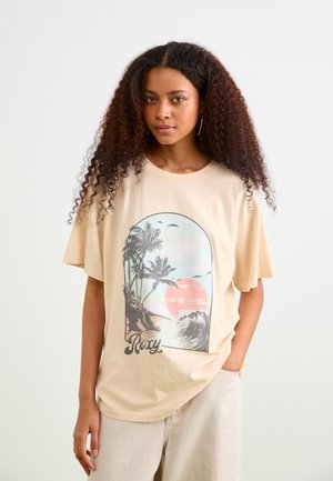 Beige T-shirt with a loose fit, featuring a beach scene graphic in pastel colors. Includes palm trees, a sunset, and "Roxy" text in black.
