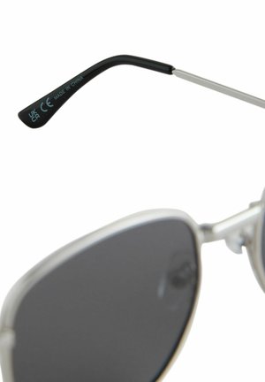 Silver sunglasses with dark lenses, featuring a sleek black temple and metal accents. Temple has text indicating "CE" and "MADE IN CHINA."