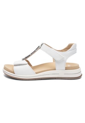 Sandale blanche en cuir ouverte à l'avant avec des brides réglables en Velcro, une semelle intérieure beige rembourrée et une semelle en caoutchouc basse pour un usage décontracté.
