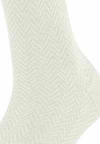 Lichtgrijze sock met een visgraatpatroon, gebreide textuur, gemiddelde hoogte en een versterkte teen en hiel voor duurzaamheid.
