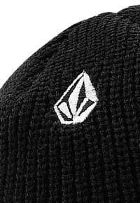 Black knitted beanie featuring a white embroidered logo on the front. The texture is ribbed and the fit is snug.