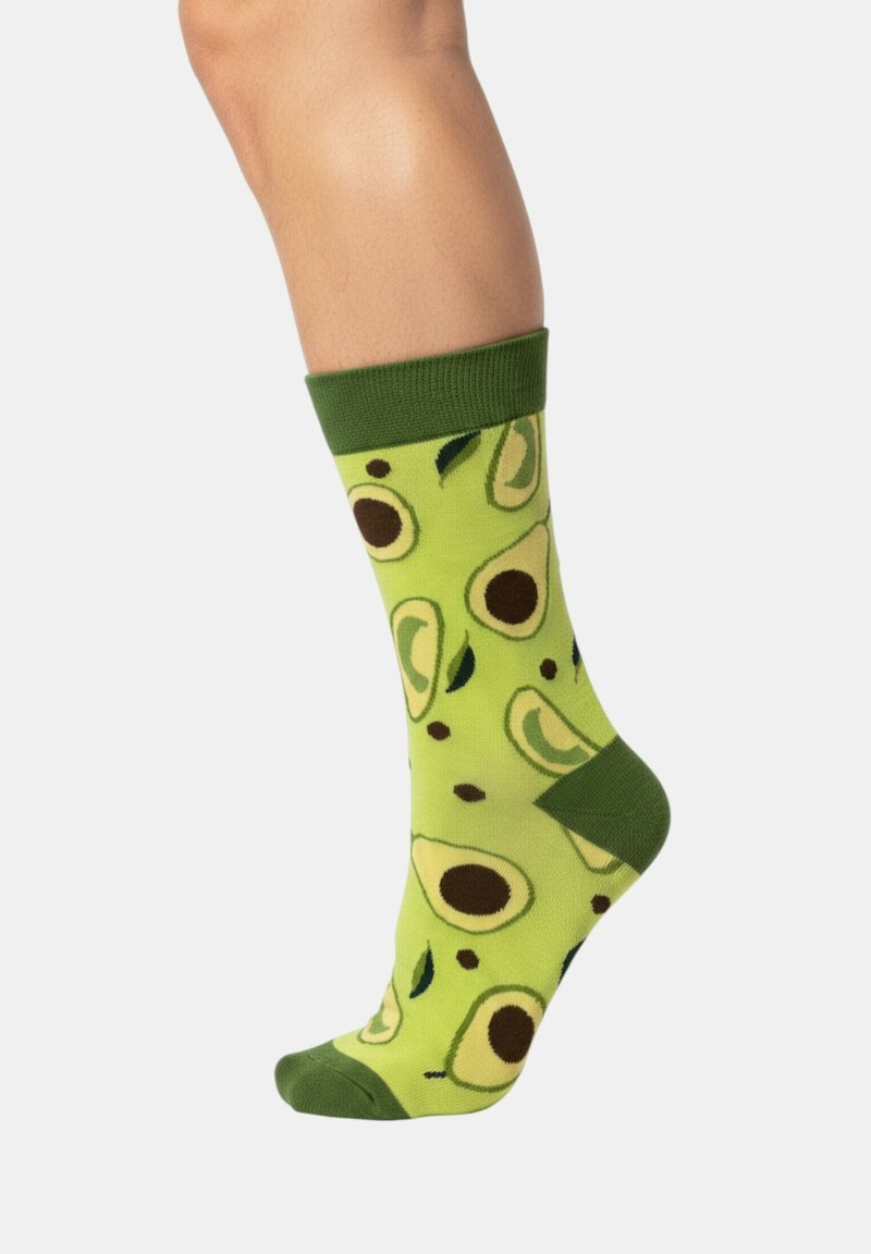 Calzini verdi con un motivo di avocati e noccioli marroni, con una manica verde scuro e una texture liscia e morbida.