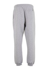 Gray sweatpants made of soft fabric, featuring an elastic waistband, side pockets, and ribbed cuffs. Simple, functional design with a relaxed fit.