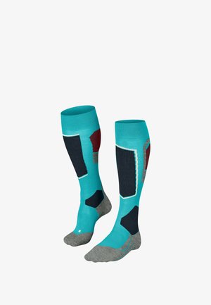 Kniesokken in turquoise, met zwarte en bordeauxrode accenten, grijze hak en teen. Gepuncteerde gebieden zorgen voor extra ondersteuning.