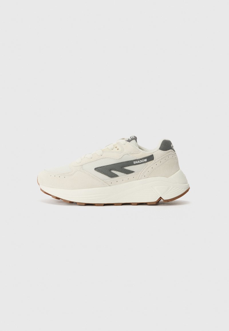 Light beige sneakers with textured suede, mesh panels, a gray logo accent, and rubber sole. Lace-up design with perforations for breathability.