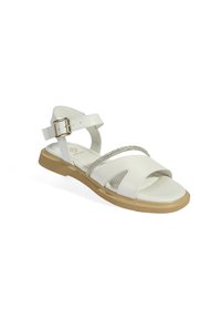 White leather sandals with a flat tan sole, featuring two thin silver-toned straps and an adjustable ankle buckle.