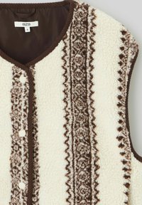 Veste sans manches en polaire crème avec des rayures marron à motifs. Dotée d'un col rond et de fermetures à pression à l'avant. Tissu texturé et douillet avec des bordures contrastantes.