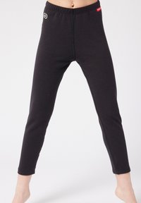 Leggings neri realizzati in un tessuto morbido, dotati di un elastico in vita, vestibilità slim e dettagli di cucitura. Accento del logo in vita.
