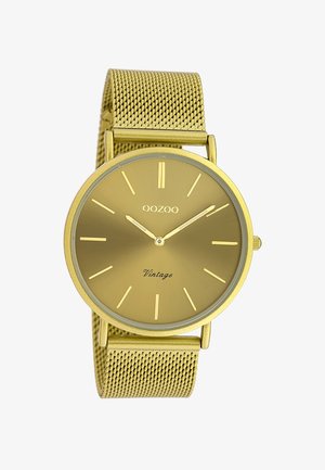 Montre OOZOO Vintage dorée avec cadran rond, index horaires minimalistes, bracelet en maille dorée, et deux aiguilles indiquant 10h09.