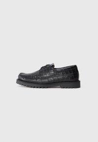 Black crocodile-embossed leather lace-up shoe with a rounded toe and textured detail. Thick black rubber sole with a ridged pattern.