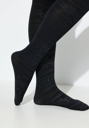 Collants noirs présentant un motif texturé de formes géométriques et de motifs, avec une finition lisse et opaque et une coupe ajustée.