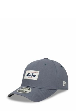 Gray baseball cap made of fabric with a rounded crown, a curved brim, and a logo patch on the front. Features eyelets for ventilation.