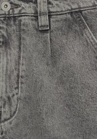 Denimjeans i en urtvattnad svart- och gråtvätt, med en klassisk femfickdesign, metalldöppning och texturerad tygutseende.